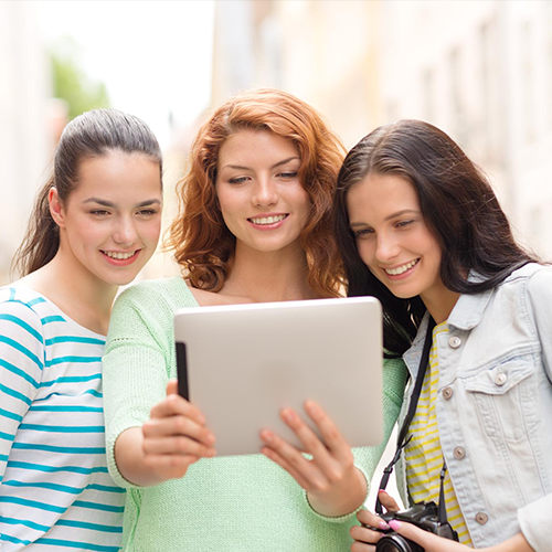 Students collaborating and boosting online presence with Student Profile Pro digital amplification services for college admissions.