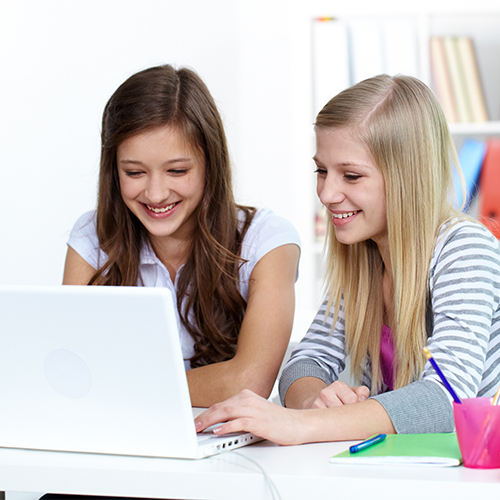 Two students collaborating on a laptop showcasing student profile pro’s digital amplification & management approach