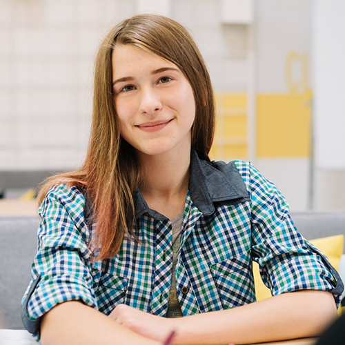 Girl smiling confidently after building an optimized student profile and branding portfolio using student profile pro services.