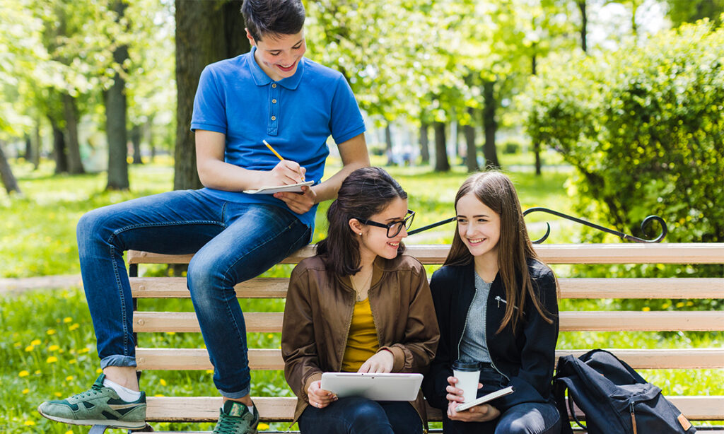 High school students building social capital through collaboration and mentorship in a park setting